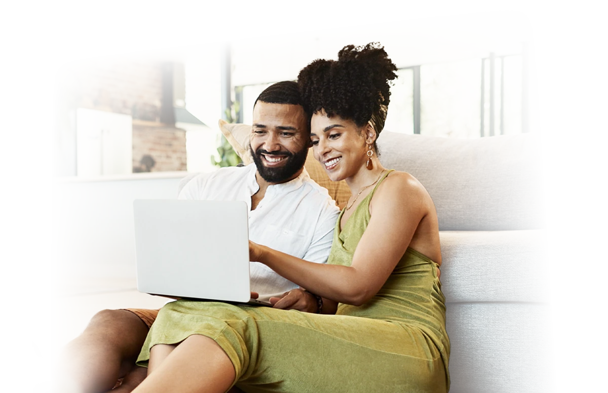 A man and a woman looking at a laptop.