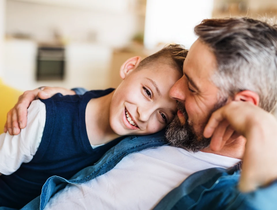 A father hugging his son.