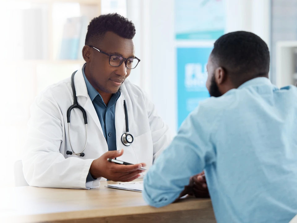 A family laughing at a television.