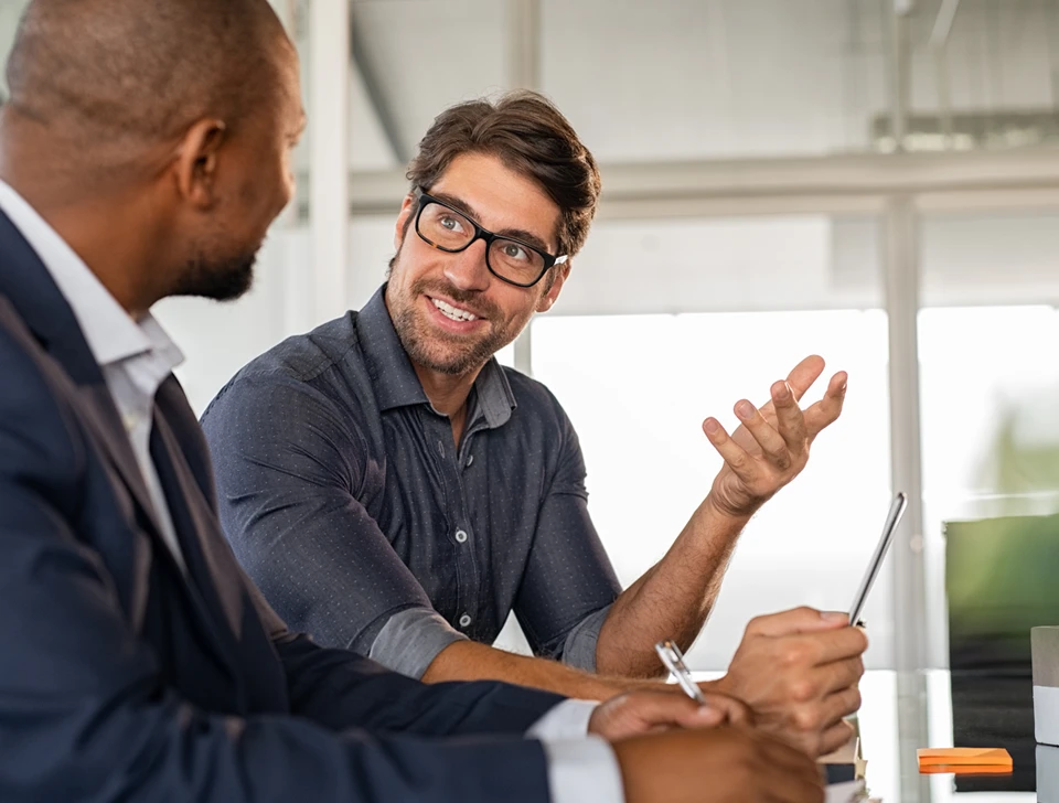 A man and a professional talking about his financial journey.
