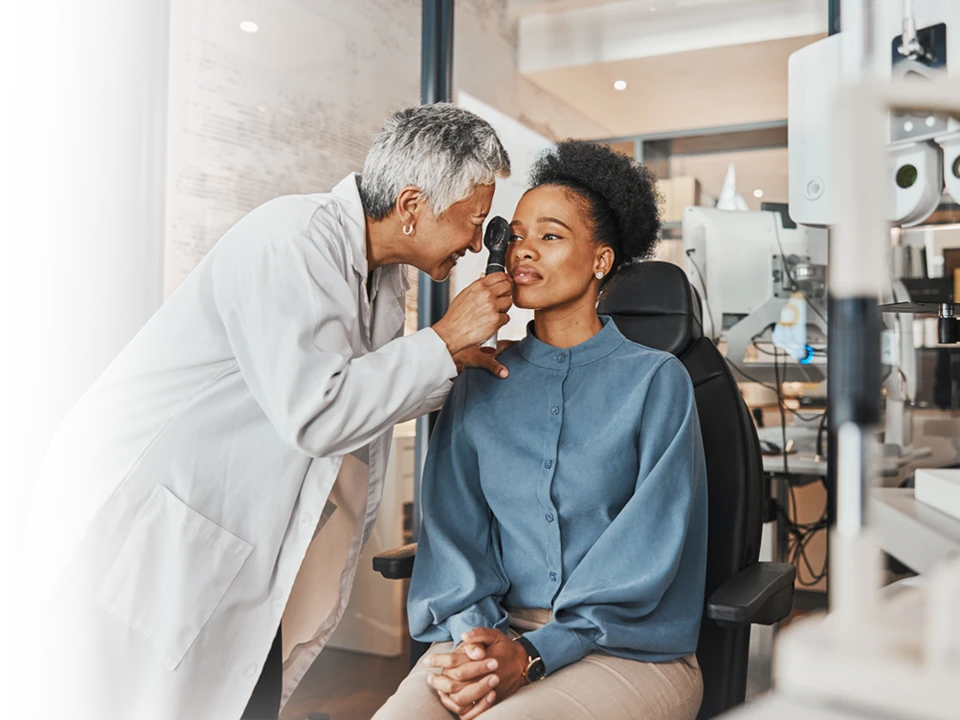 A family laughing at a television.