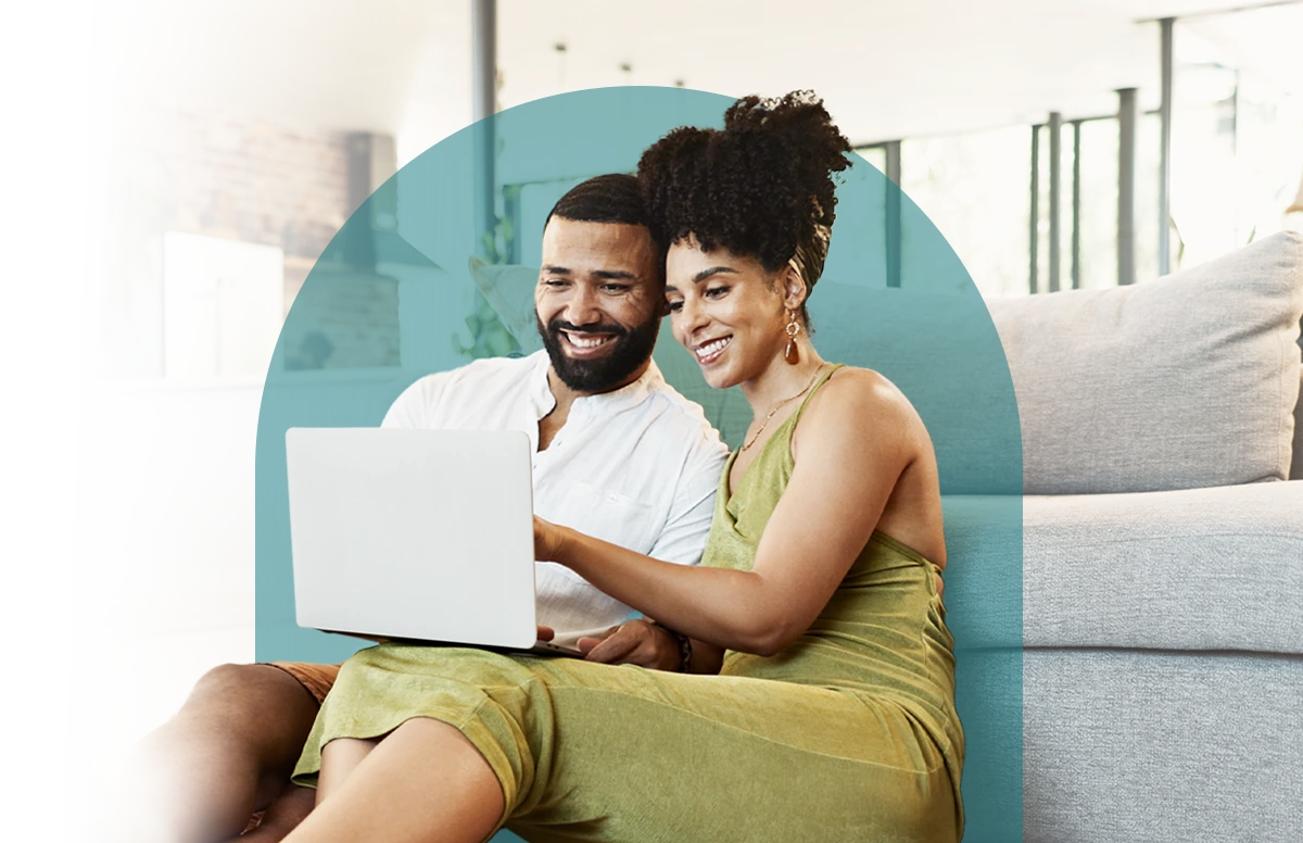 A man and a woman looking at a laptop.